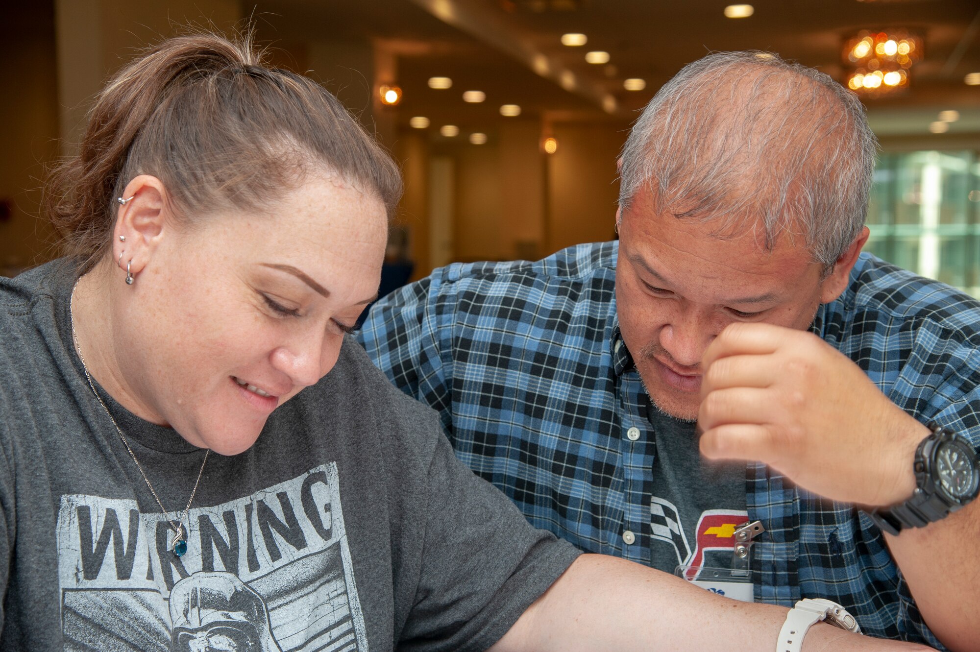 Leina’ala Leong and husband, Tech. Sgt. Samuel Leong, 154th Aircraft Maintenance crew chief complete a relationship evaluation survey as part of a Strong Bonds relationship skills workshop, Mar. 23, 2018, Honolulu, Hawaii.