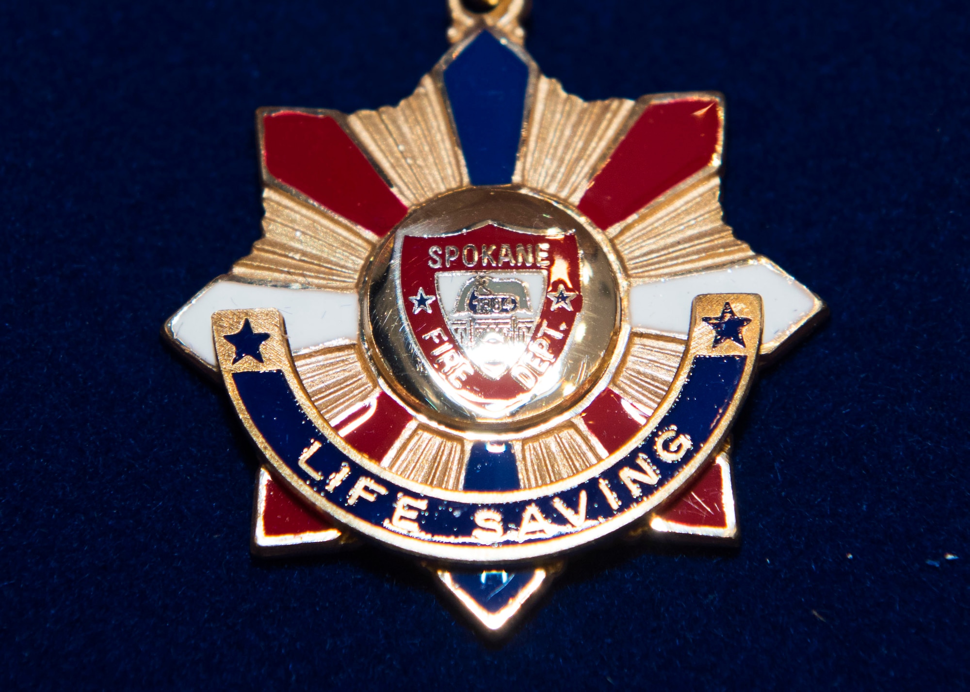 A meritorious life-saving award rests displayed during the Spokane Fire Department’s 2019 Meritorious Awards ceremony at the Spokane Fire Department Training Facility in Spokane, Washington, March 27, 2019. U.S. Air Force Master Sgt. Blaine Holland, 92nd Civil Engineer Squadron Fire Emergency Services superintendent, and U.S. Air Force Staff Sgt. Tyler Ferris, 92nd Maintenance Group Air Force Repair Enhancement Program technician, received the award for their actions in providing first-aid to the victim of a car accident. (U.S. Air Force photo by Airman 1st Class Lawrence Sena)