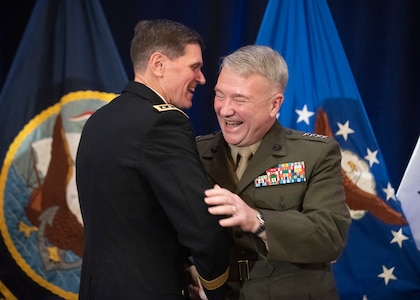 Army Gen. Joseph L. Votel embraces Marine Corps Gen. Frank McKenzie, incoming commander of U.S. Central Command, during a change of command ceremony in Tampa, Florida, March 28, 2019. McKenzie previously served as the director of the Joint Staff.