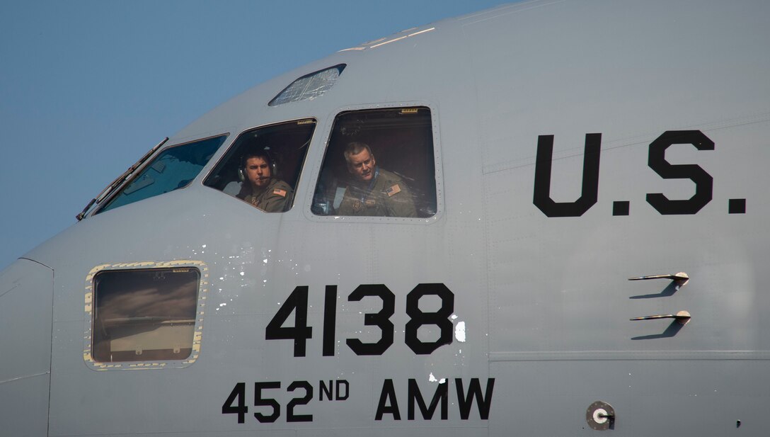 Aircrew personnel assigned to the 452nd Air Mobility Wing, March Air Force Base, Calif., perform towing procedures from the cockpit of a C-17 Globemaster III at the Langkawi International Maritime and Aerospace Exhibition 2019 in Padang Mat Sirat, Malaysia, March 23, 2019.