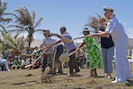 ENNIBURR, Republic of the Marshall Islands (March 26, 2019) Rear Adm. Joey Tynch, Commander, Task Force 73, and special guests dig the first holes during a ground-breaking ceremony during Pacific Partnership 2019. Pacific Partnership, now in its 14th iteration, is the largest annual multinational humanitarian assistance and disaster relief preparedness mission conducted in the Indo-Pacific. Each year, the mission team works collectively with host and partner nations to enhance regional interoperability and disaster response capabilities, increase stability and security in the region, and foster new and enduring friendships in the Indo-Pacific.