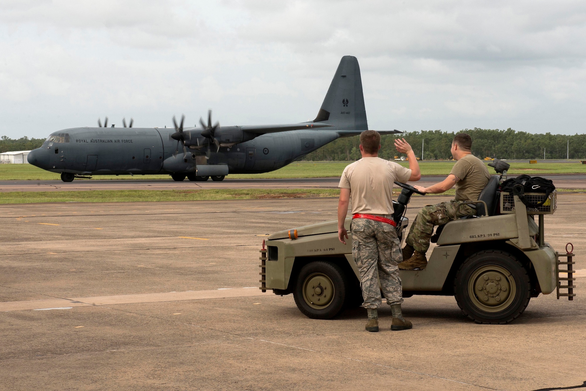 U.S. Airmen assigned to the 5th Maintenance Group wave at a passing Royal Australian Air Force (RAAF) C-130 Hercules during Diamond Shield 2019 (DS-19) at RAAF Base Darwin, Australia, March 26, 2019.