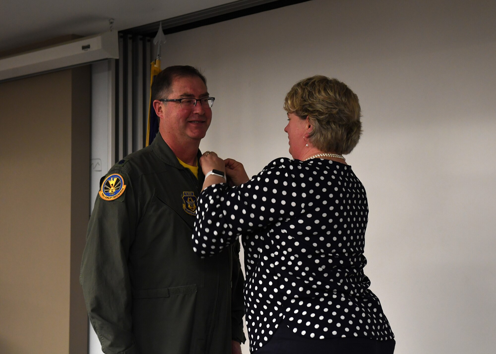 Lt. Col. Bryan Branby, chief of the 911th Airlift Wing Program Integration Office, receives his retirement pin from Laura Branby, his wife, at the Pittsburgh International Airport Air Reserve Station, Pennsylvania, March 22, 2019. Branby said his family have been there to support him throughout his career and he is glad there could be there to support him in his retirement as well. (U.S. Air Force photo by Senior Airman Grace Thomson)