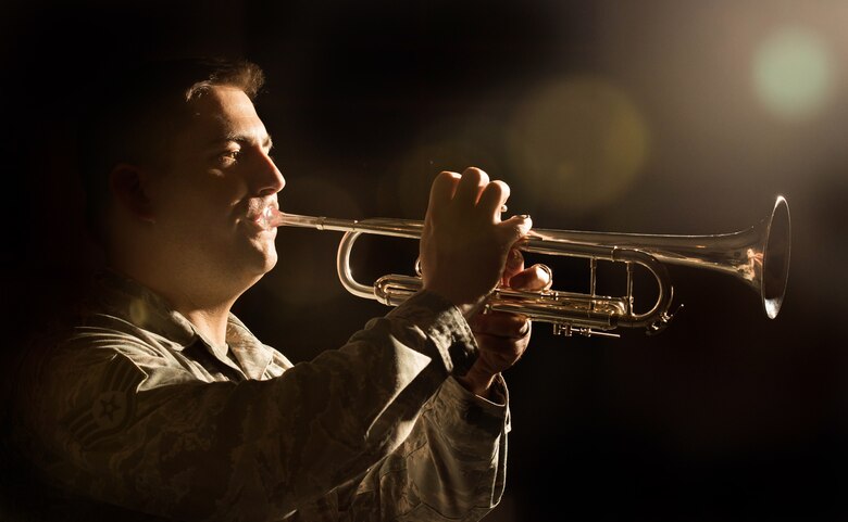An Airman plays a trumpet