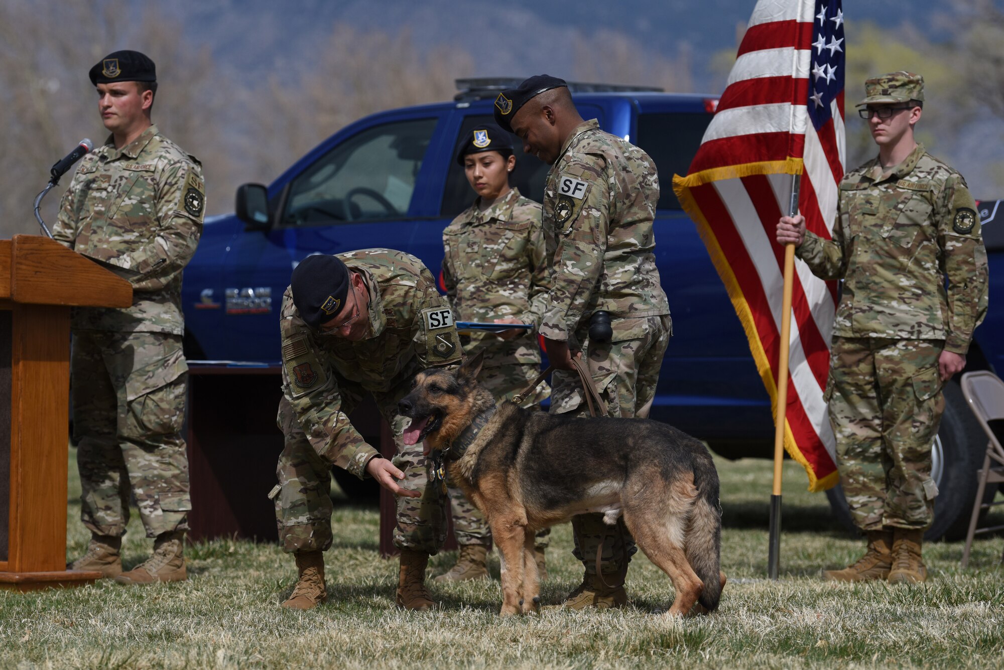 U.S. Air Force Col. Theodore Breuker, 377th Security Forces Group commander, presents Military Working Dog Boris with a Commendation Medal during Boris’s retirement ceremony at Kirtland Air Force Base, N.M., March 26, 2019. Boris retired after serving eight years at Kirtland, during which he suffered multiple heat related injuries as well as battled and defeated cancer. (U.S. Air Force photo by Senior Airman Eli Chevalier)