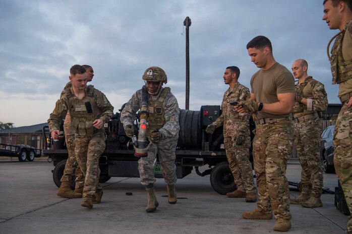 Col. Terrence Adams, 628th Air Base Wing commander, carries a fuel hose during a forward area refueling point team tryout March 26, 2019, at Joint Base Charleston, S.C.