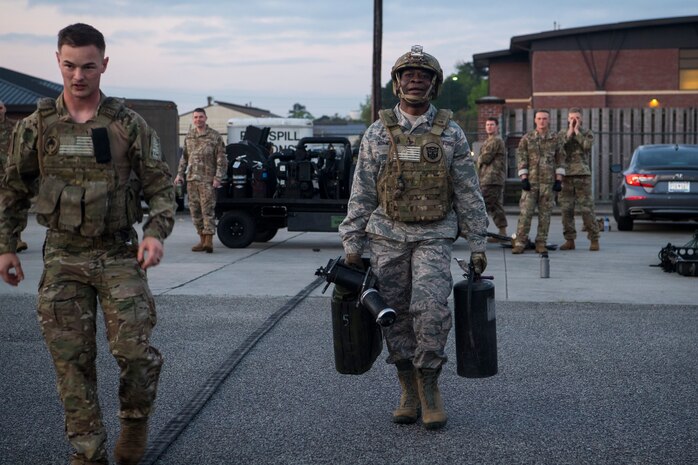 Col. Terrence Adams, 628th Air Base Wing commander, carries refueling supplies during a forward area refueling point team tryout March 26, 2019, at Joint Base Charleston, S.C.