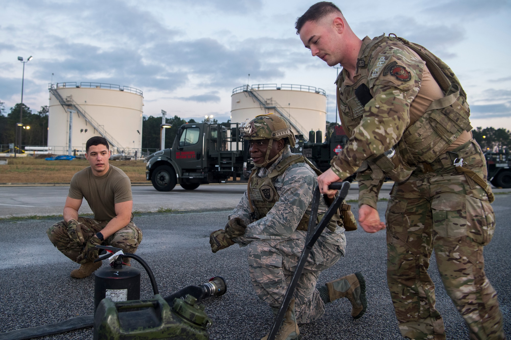 Col. Terrence Adams, 628th Air Base Wing commander, takes a knee at a checkpoint during a forward area refueling point team tryout March 26, 2019, at Joint Base Charleston, S.C.