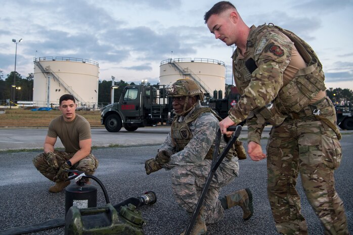 Col. Terrence Adams, 628th Air Base Wing commander, takes a knee at a checkpoint during a forward area refueling point team tryout March 26, 2019, at Joint Base Charleston, S.C.