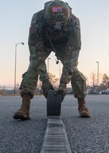 Chief Master Sgt. Todd Cole, 628th Air Base Wing command chief, rolls a refueling hose during a forward area refueling point team tryout March 26, 2019, at Joint Base Charleston, S.C.