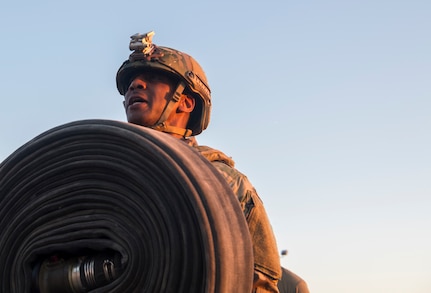 Chief Master Sgt. Todd Cole, 628th Air Base Wing command chief, carries a fuel hose during a forward area refueling point team tryout March 26, 2019, at Joint Base Charleston, S.C.