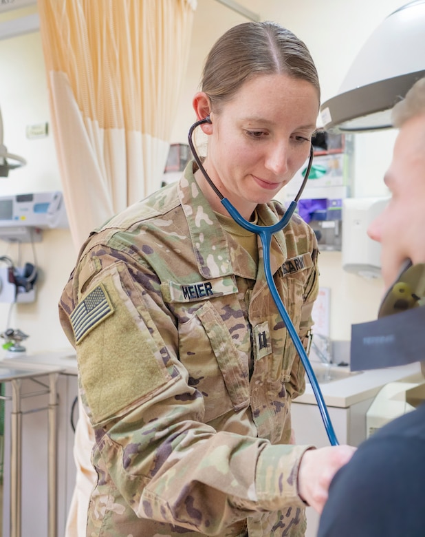 Capt. Heather Meier, 452d Combat Support Hospital, checks a patient's heartbeat at Camp Arifjan, Kuwait, Feb. 22, 2019.