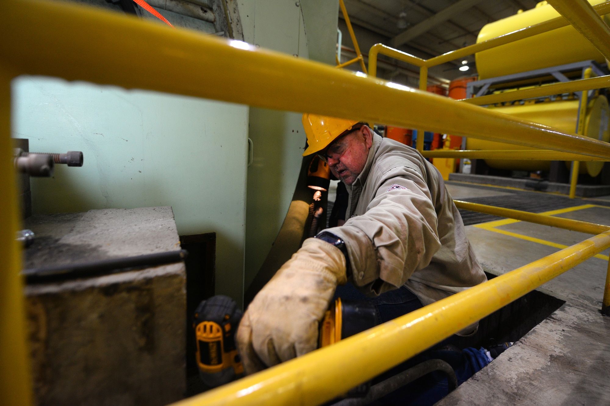 Mike Hoffmann, 55th Civil Engineer Squadron power support systems mechanic, removes the housing of a alternator on Offutt Air Force Base, Nebraska, March 28, 2019. The Missouri River flooding encroached the power supply house (U.S. Air Force photo by Josh Plueger)