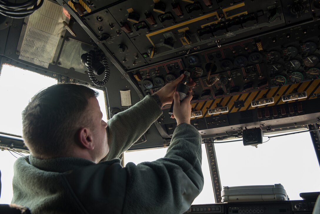 Airmen repairing console.