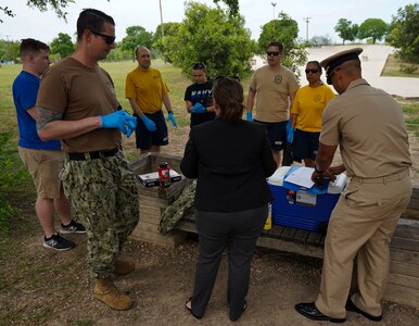 Sailors assigned to Navy Medicine Education, Training and Logistics Command at Joint Base San Antonio-Fort Sam Houston receive a safety brief from park officials before picking up trash during a community relations event held at Martinez Park during a Sailor 360 event. Sailor 360 is command-level program for junior enlisted, senior enlisted and junior officers designed to strengthen and develop leadership through COMREL events, classroom discussions and physical training events.