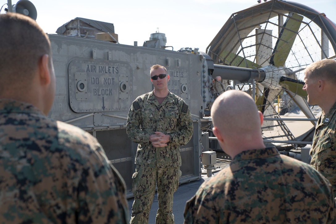 U.S. Navy Chief Eric Waters, a quarter master with Detachment 1, Assault Craft Unit FOUR, speaks to Marines and Sailors with U.S. Marine Corps Forces Command during a tour of the Landing Craft, Air Cushion March 29, 2019, aboard Joint Expeditionary Base Little Creek in Virginia Beach, Virginia. The tour was an opportunity for the Marines and Sailors to learn more about the craft and see it first-hand. An LCAC is an air cushion vehicle for transporting personnel, weapons, equipment, and cargo of the assault elements of the Marine Air-Ground Task Force from ship-to-shore. (U.S. Marine Corps photo by Cpl. Danielle R. Prentice/ Released)