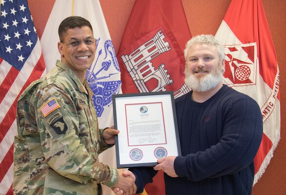 TAD Commander Col. Mark C. Quander, presents the Employee of the Quarter Award for Oct-Dec 2018 to Transatlantic Division Emergency Management Specialist Carey L. Grubbs, during a ceremony held at the TAD headquarters in Winchester, Va. in Feb. 28, 2019. Quander lauded Grubbs for his great work, spearheading several highly visible and planning-intensive initiatives for TAD’s Plans and Operations Center.