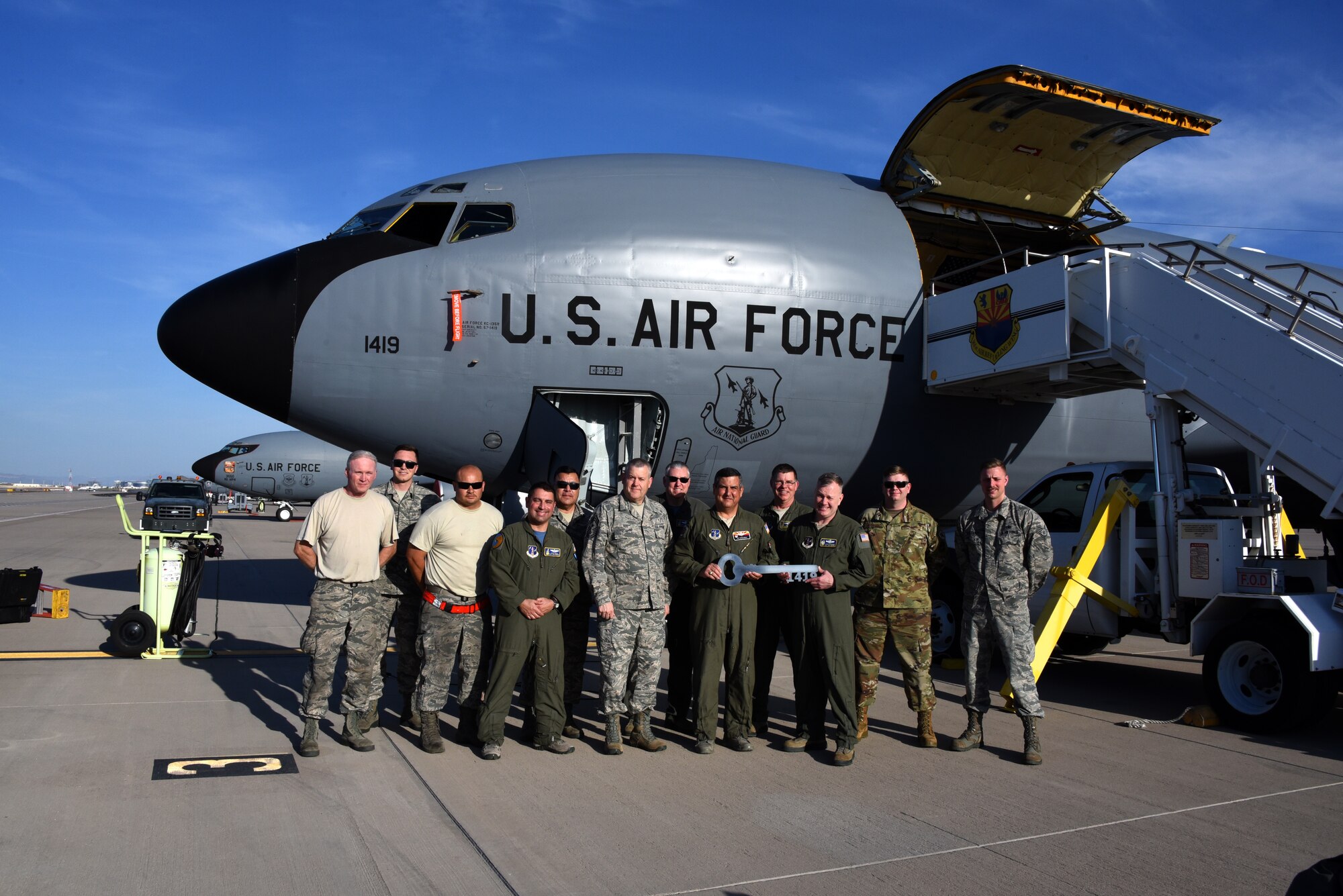 Col. Patrick Donaldson, commander, 161st Air Refueling Wing, Goldwater Air National Guard Base, Phoenix, accepts the key to KC-135 Stratotanker 57-1419 from Col. John Pogorek, commander, 157th Air Refueling Wing, Pease Air National Guard Base, N.H., March 24, 2019. (Photo by Master Sgt. Kelly Deitloff)