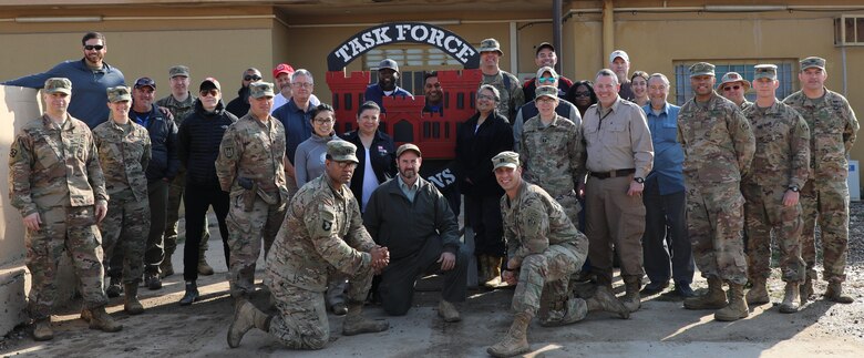Members of the U.S. Army Corps of Engineers Transatlantic Division's Task Force Essayons, headquartered at Camp Taji, Iraq, pose in front of their building. The team was presented with an award for voting their organization a one of the "Best Places To Work" in the Federal Government.