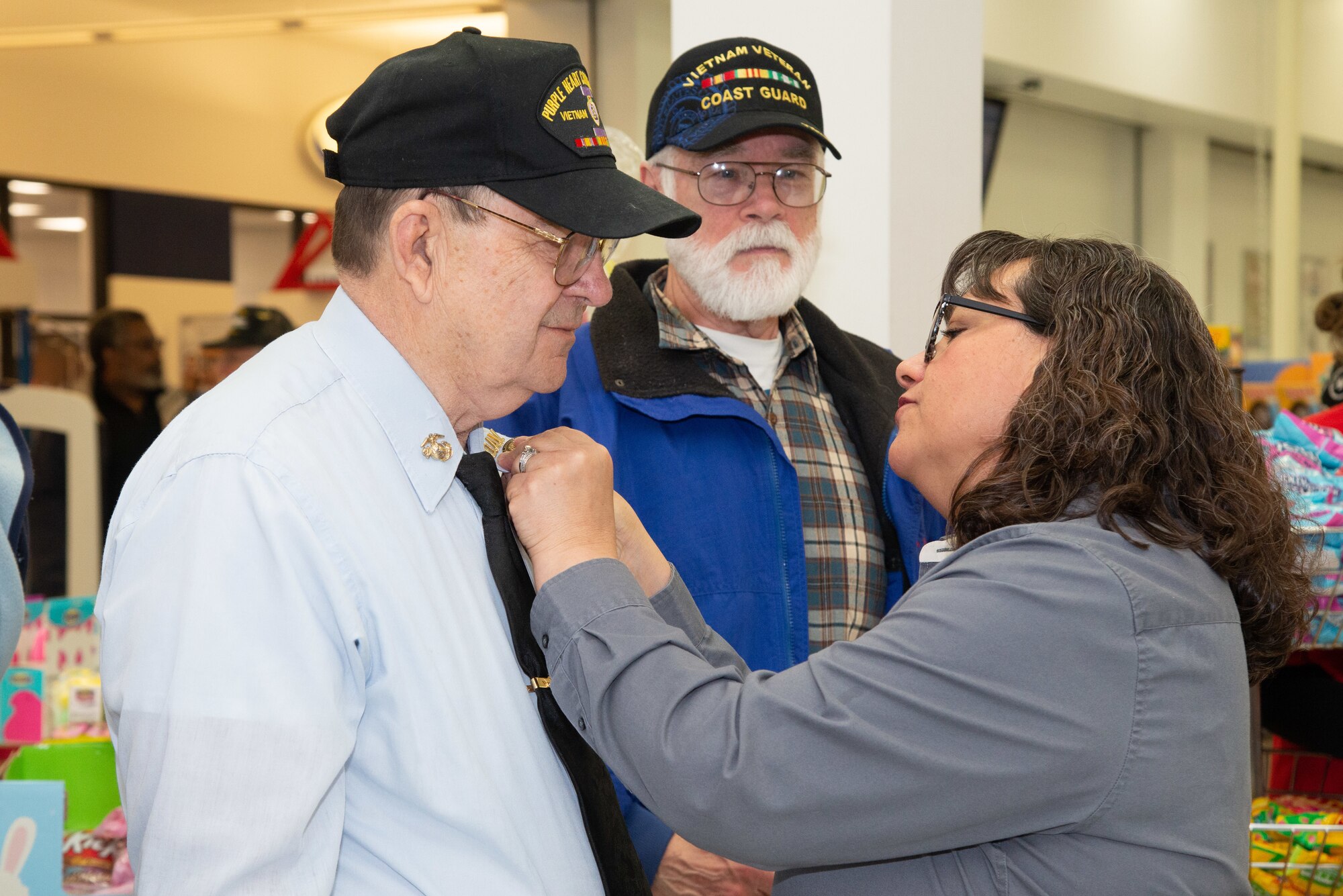 Christina Griffen, Main Exchange store manager, pins John Mizell, U.S. Marine veteran, with a Vietnam Veteran Pin March 29, 2019, at the Main Exchange at Hill Air Force Base, Utah. Base Exchanges around the world hosted pinning ceremonies to honor Vietnam veterans on Vietnam Veterans Day. Vietnam Veterans Day is celebrated every March 29 to honor the courage and sacrifice of those who served in the Vietnam War. (U.S. Air Force photo by Cynthia Griggs)