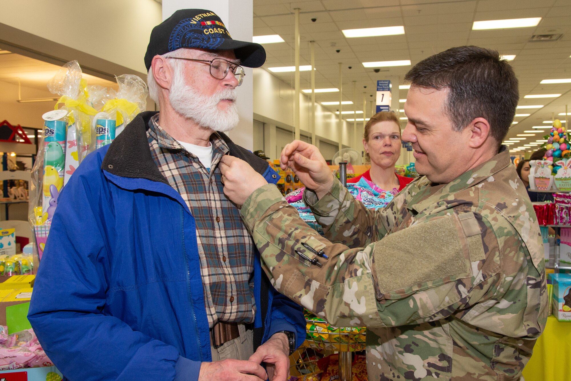 Colonel Gabe Lopez, 75th Mission Support Group commander, pins Mike Glenn, U.S. Coast Guard veteran, with a Vietnam Veteran Pin March 29 2019, at the Main Exchange at Hill Air Force Base, Utah. Base Exchanges around the world hosted pinning ceremonies to honor Vietnam veterans on Vietnam Veterans Day. Vietnam Veterans Day is celebrated every March 29 to honor the courage and sacrifice of those who served in the Vietnam War. (U.S. Air Force photo by Cynthia Griggs)