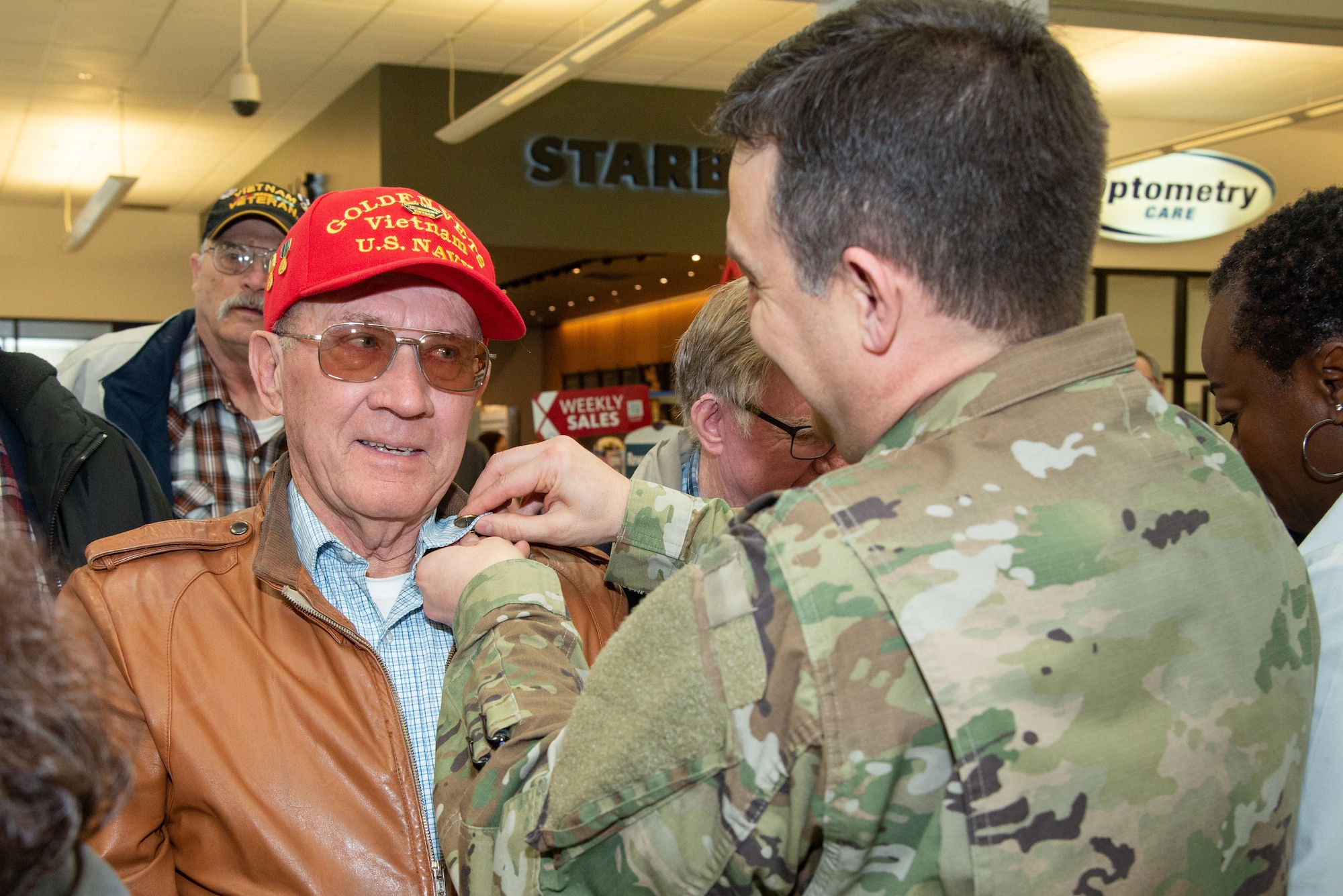Col. Gabe Lopez, 75th Mission Support Group commander, pins Bill Kelley, U.S. Navy Veteran, with a Vietnam Veteran Pin March 29, 2019, at the Main Exchange at Hill Air Force Base, Utah. Base Exchanges around the world hosted pinning ceremonies to honor Vietnam veterans on Vietnam Veterans day. Vietnam Veterans Day is celebrated every March 29 to honor the courage and sacrifice of those who served in the Vietnam War. (U.S. Air Force photo by Cynthia Griggs)