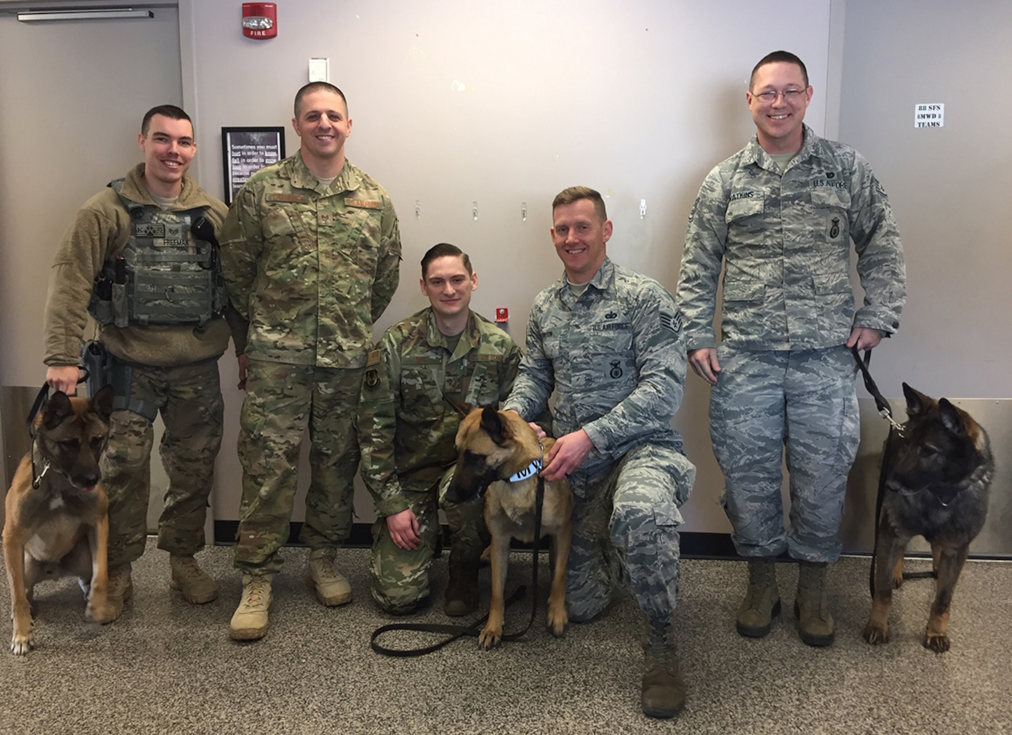 Assigned to the 88th Security Forces Squadron at Wright-Patterson Air Force Base are, shown left to right: Staff Sgt. Marshall Freeman with Military Working Dog Rudo; MWD Kennel Master Tech. Sgt. Adam Chambers; Staff Sgt. William Sims Jr. with MWD Misha; MWD trainer Staff Sgt. Philip Mason; Staff Sgt. Matthew Watkins with MWD Casey. (Skywrighter photo/Amy Rollins)