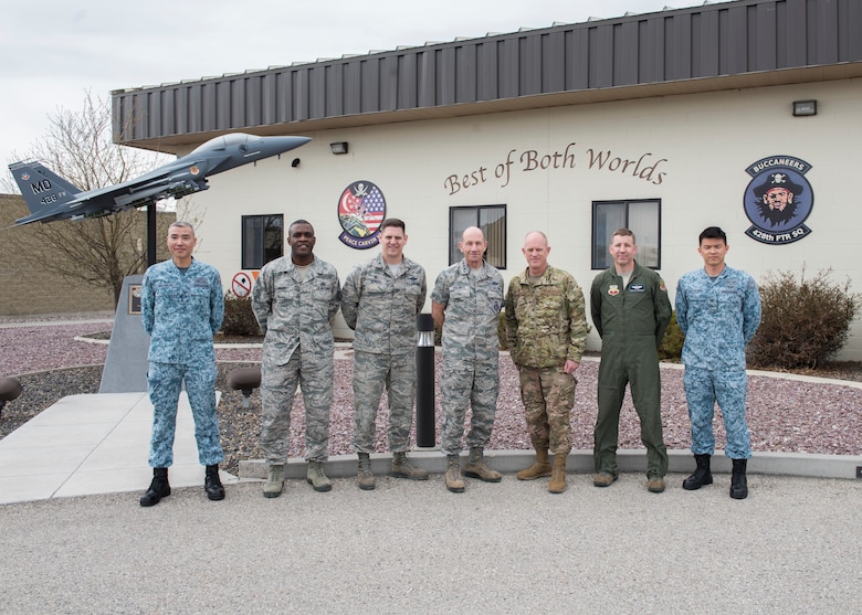 U.S. Air Force Gen. Mike Holmes, commander of Air Combat Command, and Chief Master Sgt. Frank Batten, ACC command chief, take a group photo with leadership from the 428th Fighter Squadron, March 27, 2019, at Mountain Home Air Force Base, Idaho. The 428th Fighter Squadron are members from Peace Carvin V of the Republic of Singapore Air Force. (U.S. Air Force photo by Senior Airman Tyrell Hall)