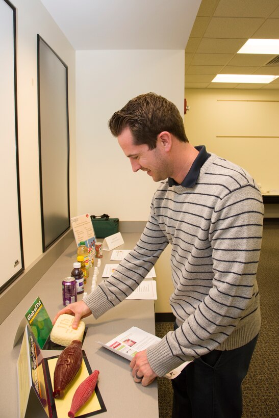 Kyle Shireman, safety manager with the Huntsville Center Safety Office, checks out the hands-on health exhibits from the Redstone Arsenal Center for Comprehensive Wellness before a lunchtime presentation from Mary Bouldin, a nurse educator, in Huntsville, Alabama, March 29, 2019.