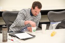 Kyle Shireman, a safety manager with the Huntsville Center Safety Office, takes part in a hands-on activity as part of a lunchtime presentation from Mary Bouldin, a nurse educator from the Redstone Arsenal Center for Comprehensive Wellness, in Huntsville, Alabama, March 29, 2019.