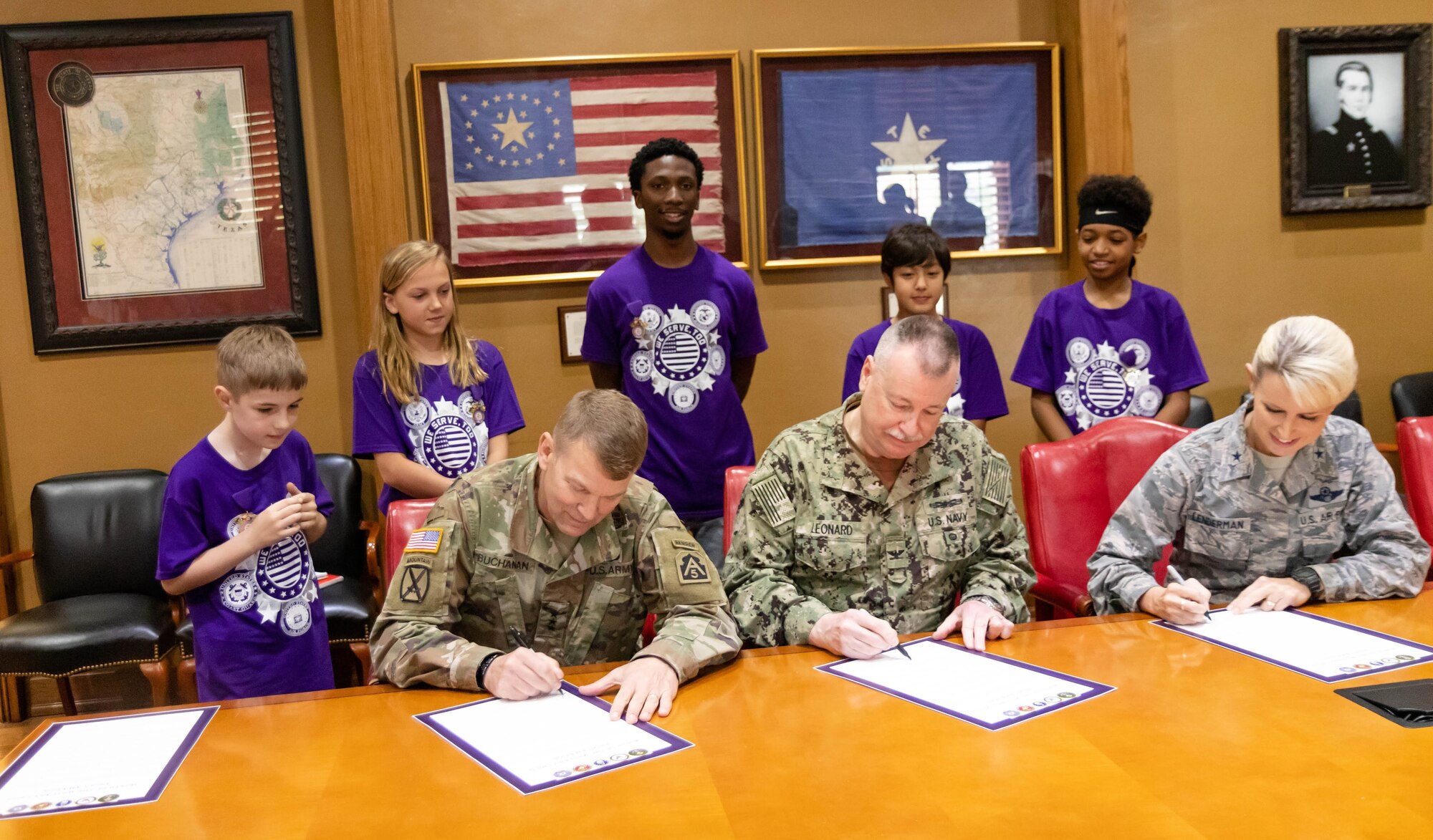 Joint Base San Antonio leaders recognized the contributions of military children and families during a proclamation ceremony designating April as Month of the Military Child at JBSA-Fort Sam Houston March 29. The ceremony was held in the Texas Room at the U.S. Army North (Fifth Army) Headquarters. Signing the proclamation were (from left)  Lt. Gen. Jeffrey Buchanan, ARNORTH commanding general; Capt. William Leonard, Navy Medicine Education and Training Command deputy commander; and Brig. Gen. Laura L. Lenderman, JBSA and 502nd Air Base Wing commander. Also attending the proclamation signing were five students from the Fort Sam Houston Independent School District and their parents.