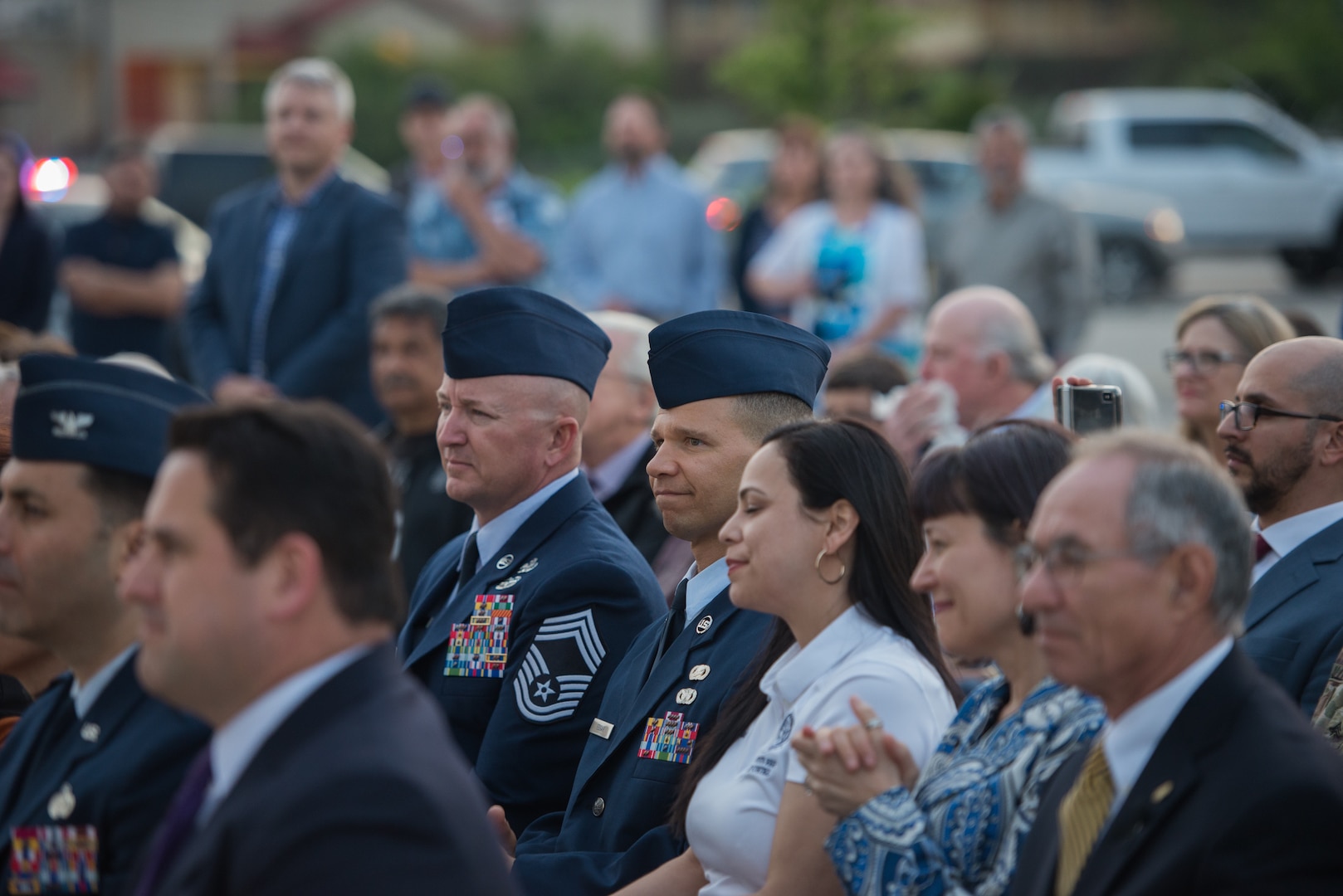 Chief Master Sergeants Edward H. Edgar and Scott N. Ranson listen to opening remarks at the Tribute to Freedom sculpture grand opening, Mar. 27, 2019, at the corner of U.S. Highway 90 and Military Drive.