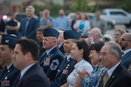 Chief Master Sergeants Edward H. Edgar and Scott N. Ranson listen to opening remarks at the Tribute to Freedom sculpture grand opening, Mar. 27, 2019, at the corner of U.S. Highway 90 and Military Drive.