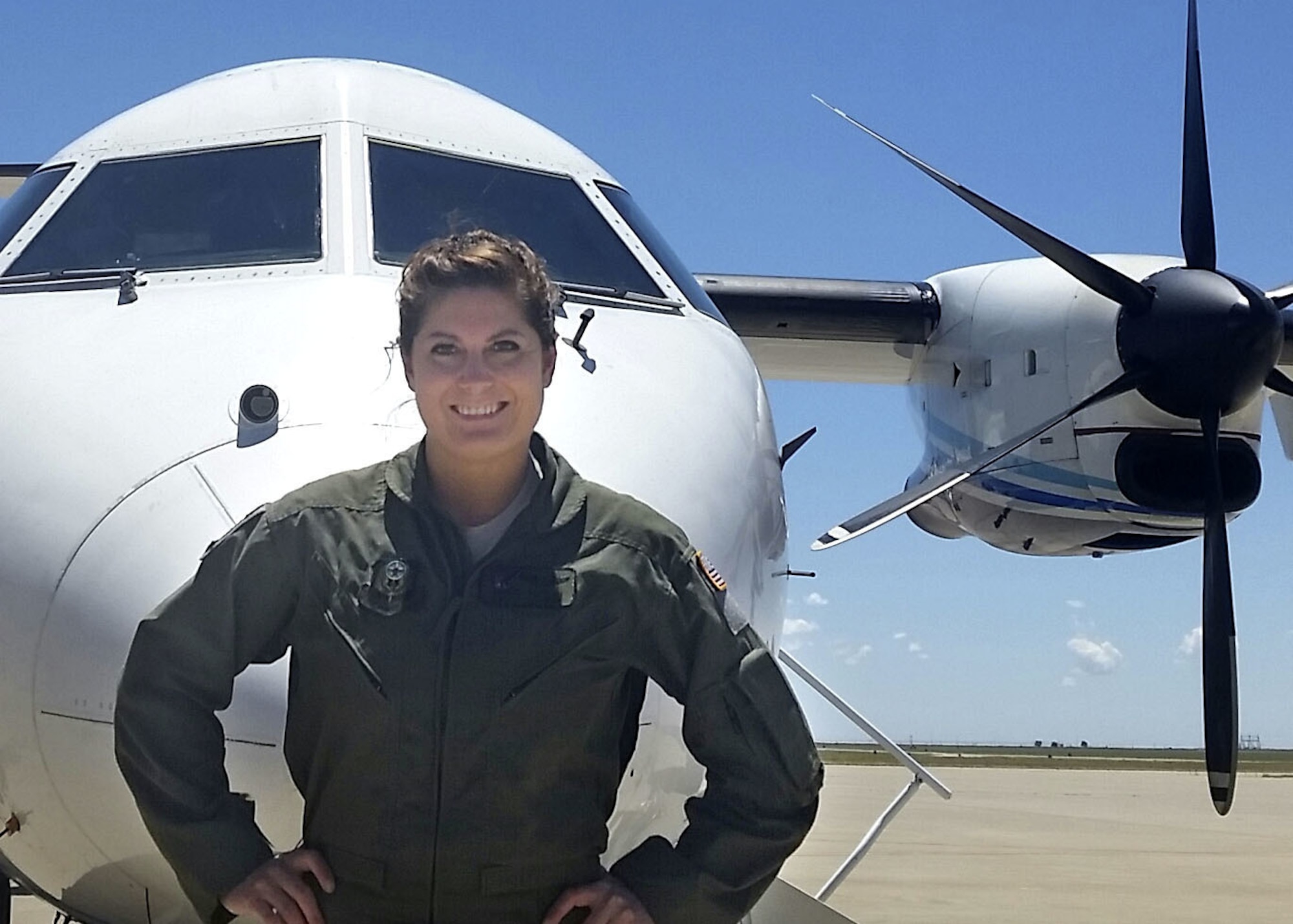 Photo of femal Air Force officer in from of C-146A Wolfhound aircraft