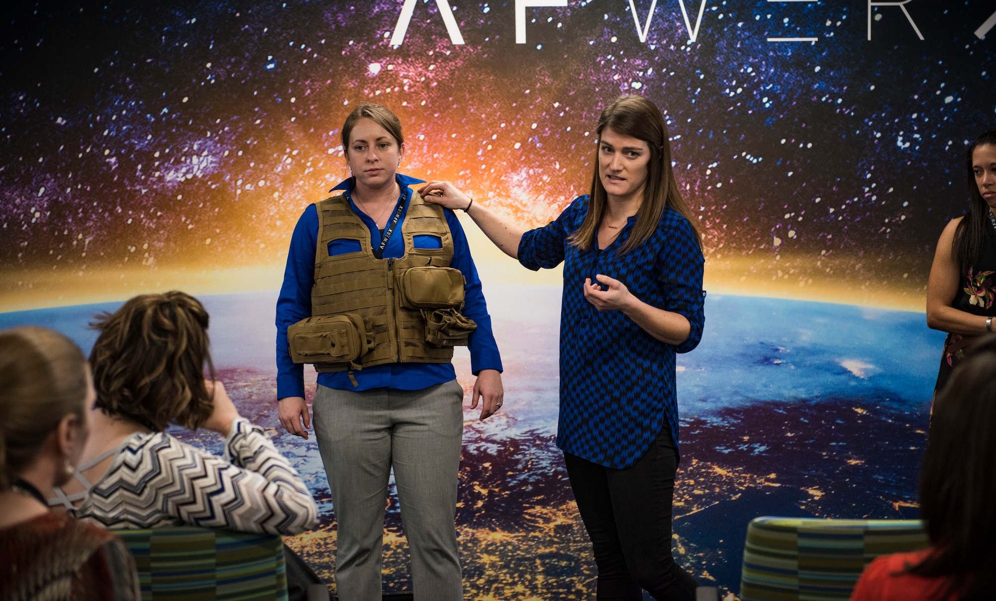 Two female pilots demonstrate a sizing issue related to survival vests.