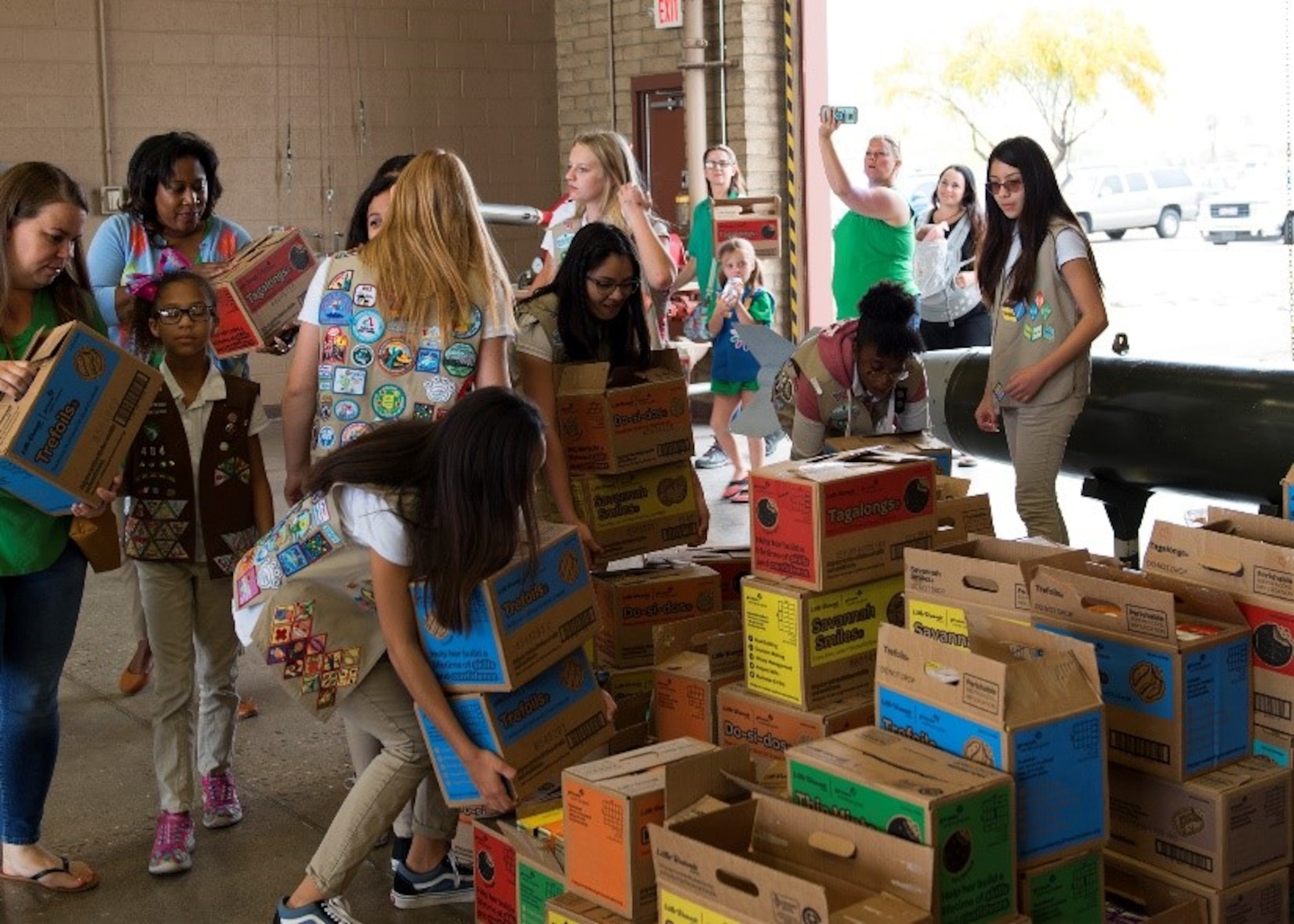 Girl Scouts arrange boxes of cookies for Airmen at Luke Air Force Base, Ariz., March 27, 2019. The Girl Scouts have been donating to Luke for over 10 years and gave more than 100 boxes this year. (U.S. Air Force photo by Airman 1st Class Leala Marquez)