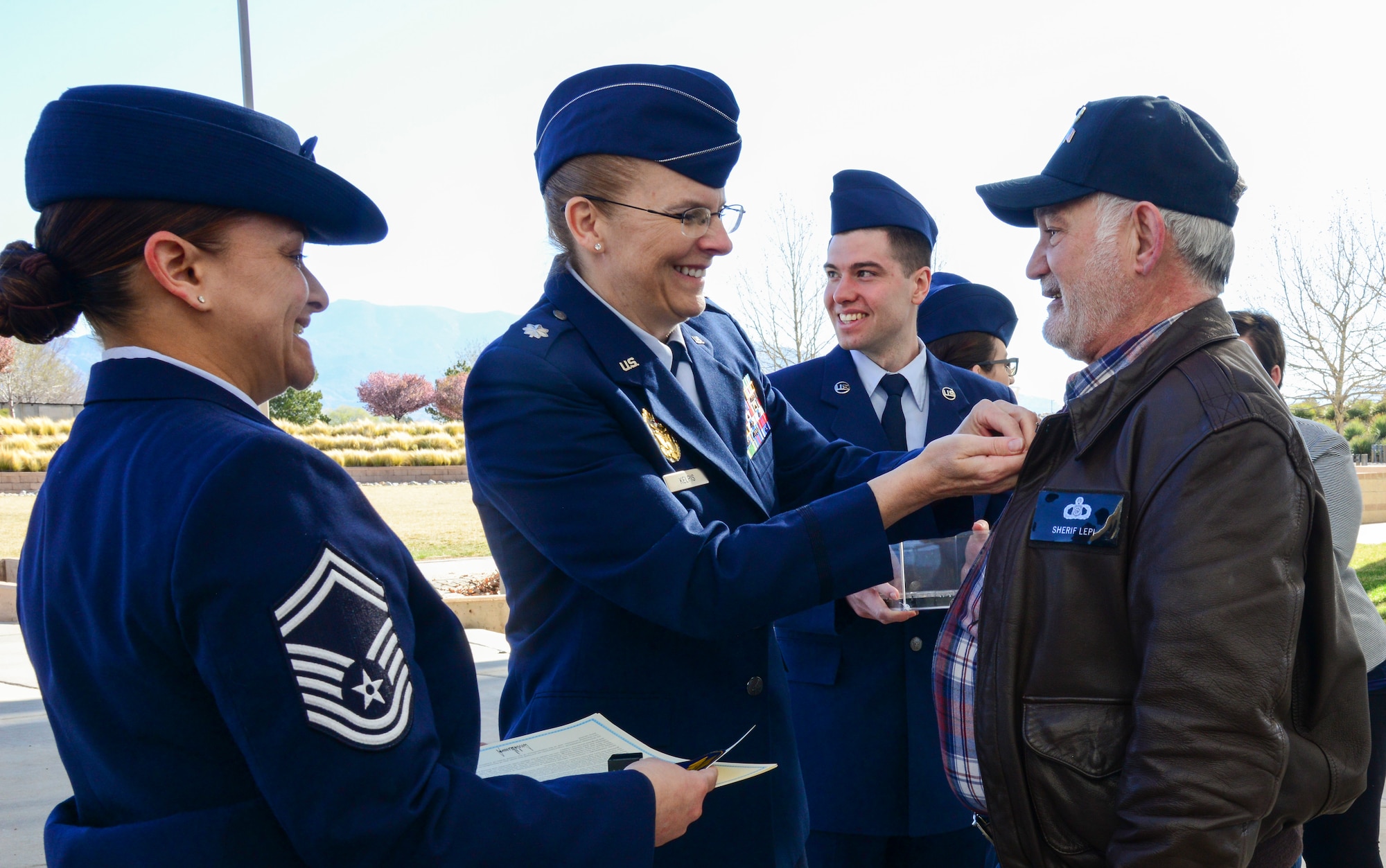 Lt. Col. Samantha Kelpis, with the Air Force Inspection Agency, pins Sherif Lepi during a ceremony to commemorate Vietnam Veterans Day at the New Mexico Veterans Memorial, March 29, 2019. Various organizations from Kirtland Air Force Base, including the Defense Commissary Agency and the Army and Air Force Exchange Service worked together to make the ceremony special for the state's Vietnam veterans. (U.S. Air Force photo by Jessie Perkins)