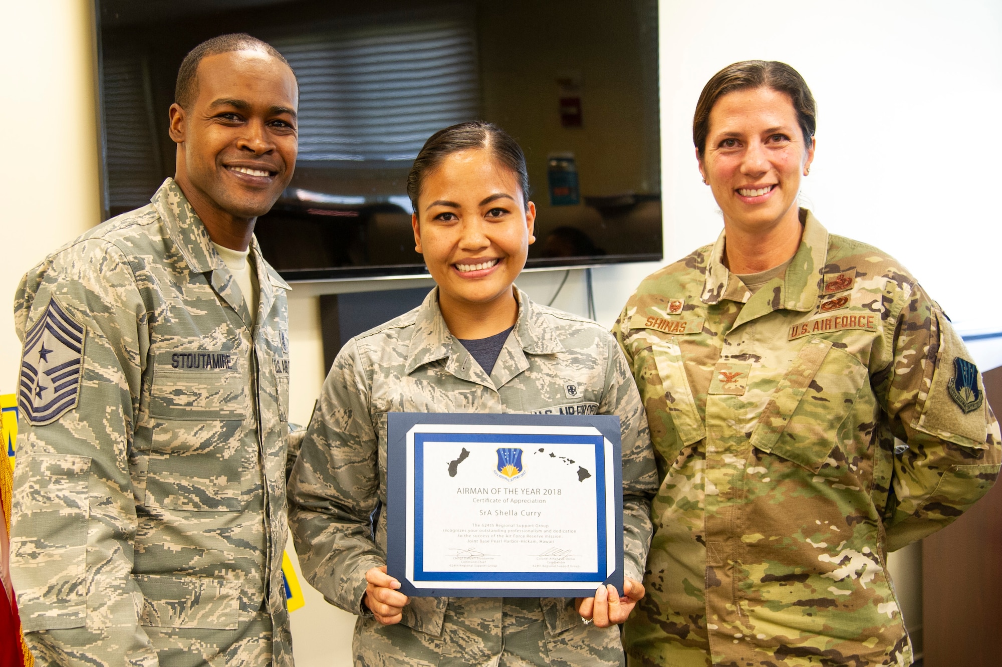 Senior Airman Shella Curry, a Reserve Citizen Airmen from the 624th Regional Support Group, receives the Group’s 2018 Airman of the Year award from Col. Athanasia Shinas, 624th RSG commander, and Chief Master Sgt. Danyell Stoutamire, 624th RSG command chief, during an awards presentation March 3, 2019, at Joint Base Pearl Harbor-Hickam, Hawaii.
