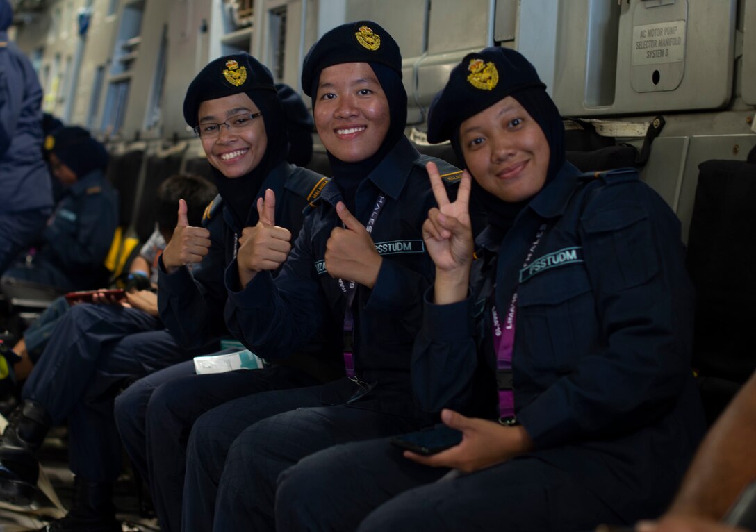 Members of the Malaysian Defence Force pose for a photo in a C-17 Globemaster III, assigned to the 452nd Air Mobility Wing, March Air Force Base, Calif., during the Langkawi International Maritime and Aerospace Exhibition 2019 in Padang Mat Sirat, Malaysia, March 29, 2019.