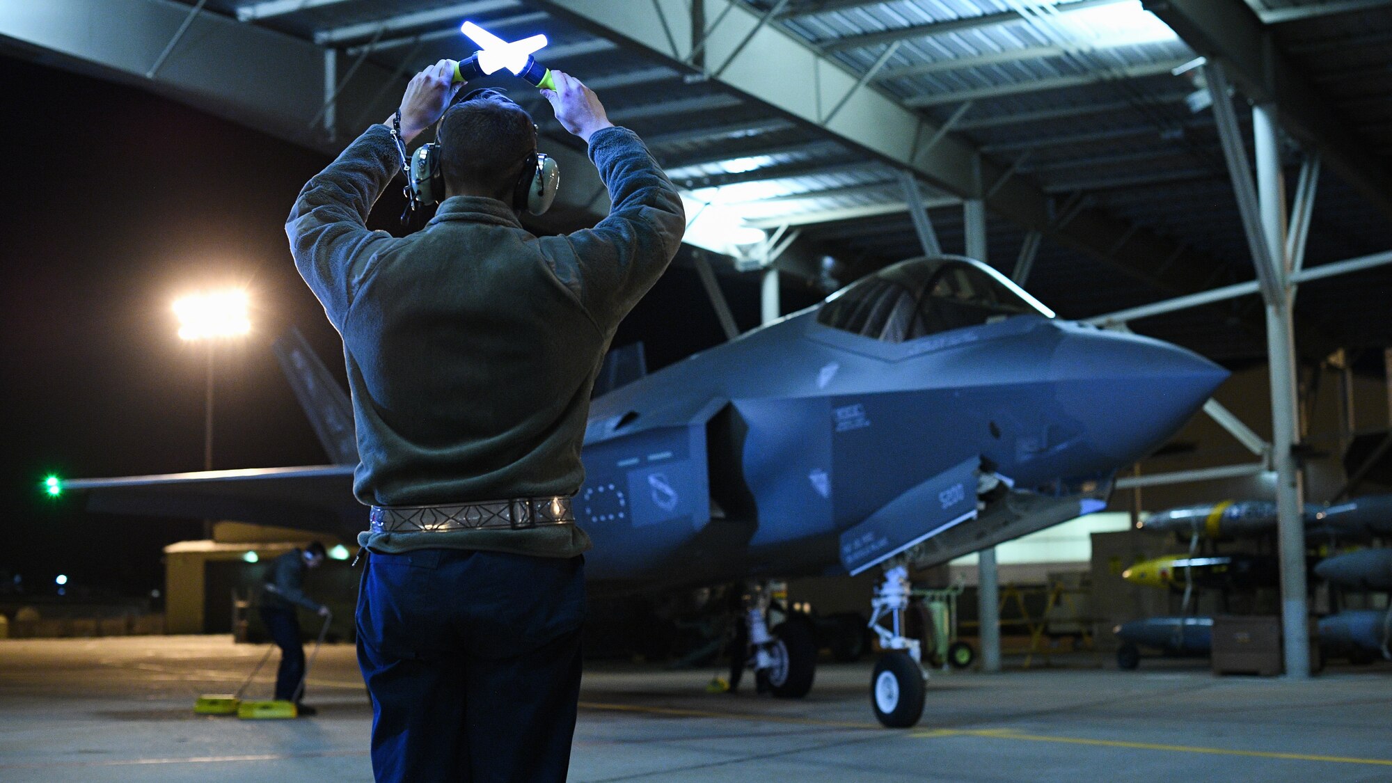 An Airman from the 388th Fighter Wing’s 421st Aircraft Maintenance Unit marshals an F-35A Lightning II during night flying operations at Hill Air Force Base, Utah, March 26, 2019. Night flying is required for pilots to sharpen their combat skills and maintainers work around the clock to prepare jets for flight, inspect them after flight, and get them ready for the next flying day. The 388th Fighter Wing is the Air Force’s first combat-coded F-35A wing. (U.S. Air Force photo by R. Nial Bradshaw)