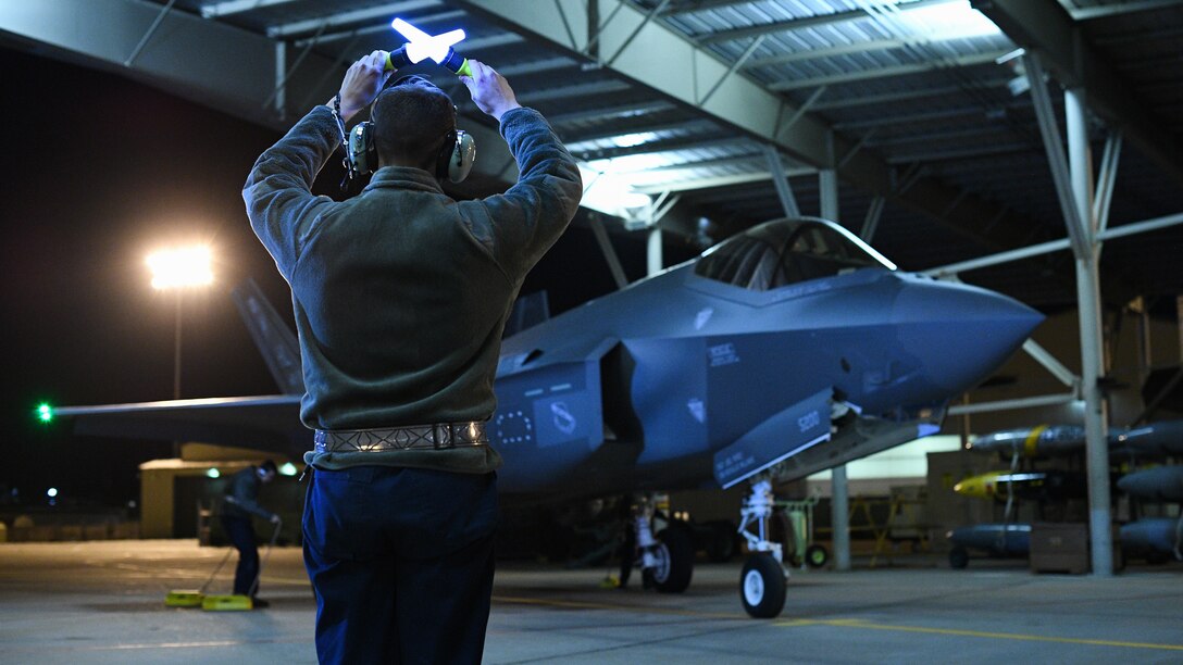 An Airman from the 388th Fighter Wing’s 421st Aircraft Maintenance Unit marshals an F-35A Lightning II during night flying operations at Hill Air Force Base, Utah, March 26, 2019. Night flying is required for pilots to sharpen their combat skills and maintainers work around the clock to prepare jets for flight, inspect them after flight, and get them ready for the next flying day. The 388th Fighter Wing is the Air Force’s first combat-coded F-35A wing. (U.S. Air Force photo by R. Nial Bradshaw)