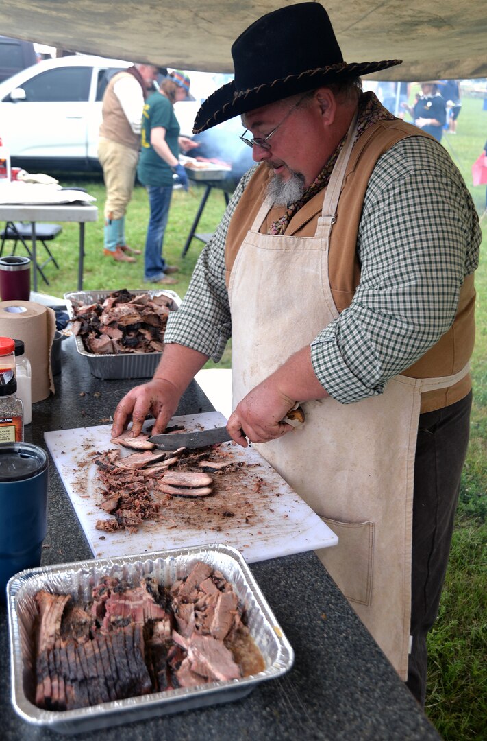 David McNutt, with the Cedar Top Chuck Wagon Ministry from Terrell, Texas, prepares beef brisket for tacos at the annual Cowboys for Heroes chuckwagon event at Joint Base San Antonio-Fort Sam Houston March 30.