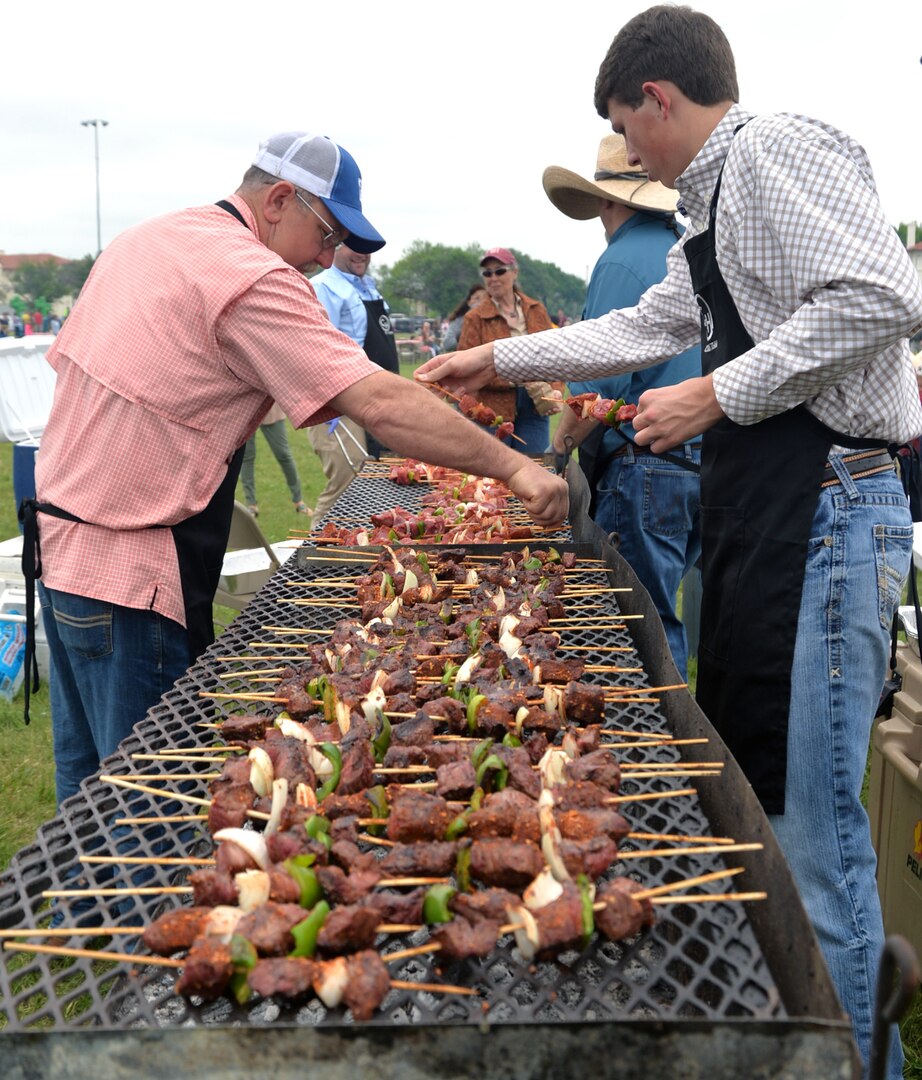 A long line of shish kebobs cooks for thousands of visitors to the annual Cowboys for Heroes chuckwagon event at Joint Base San Antonio-Fort Sam Houston March 30.