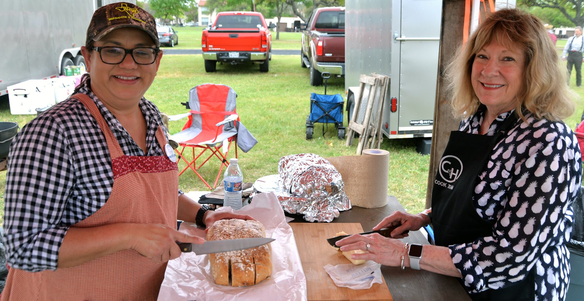 Claudia Villarreal (left) and Becky Bike (right) prepare oatmeal bread for the Ellis CW chuckwagon, out of Goliad, Texas, at the annual Cowboys for Heroes chuckwagon event at Joint Base San Antonio-Fort Sam Houston March 30.