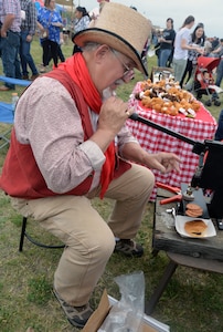 John Karnes operates an old-fashioned leather press to make some souvenirs for visitors to the annual Cowboys for Heroes chuckwagon event at Joint Base San Antonio-Fort Sam Houston March 30.