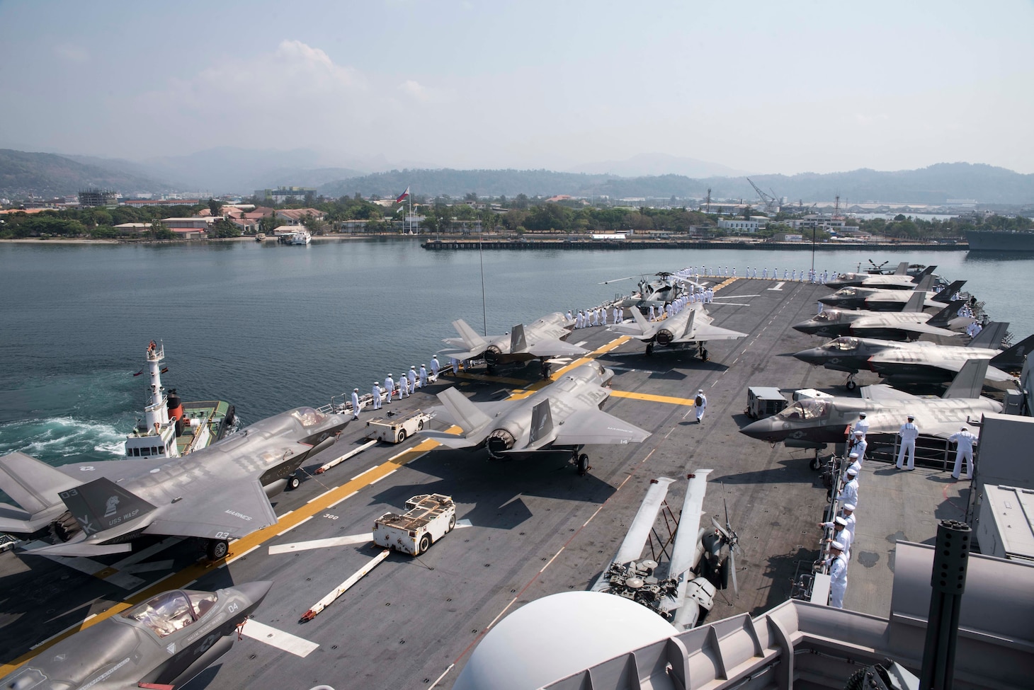 SUBIC BAY, PHILIPPINES (March 30, 2019) – Sailors aboard the amphibious assault ship USS Wasp (LHD 1) prepare to man the rails prior to arriving to Subic Bay in preparation of Exercise Balikatan. Exercise Balikatan, in its 35th iteration, is an annual U.S., Philippine military training exercise focused on a variety of missions, including humanitarian assistance and disaster relief, counter-terrorism, and other combined military operations.