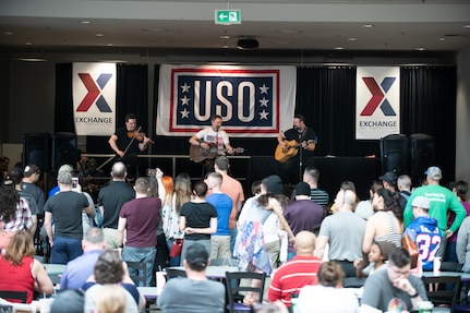 Country music artist Craig Morgan and members of his band perform during a USO show at Ramstein Air Base, Germany, the first stop on the annual Vice Chairman’s USO Tour, March 30, 2019. Celebrity chef Robert Irvine, UFC Hall of Famer BJ Penn, former UFC Middleweight champion Chris Weidman, professional mixed martal artist Felice Herrig, two-time MLB World Series champion Shane Victorino; and professional surfer Makua Rothman will join Air Force Gen. Paul J. Selva, vice chairman of the Joint Chiefs of Staff, on a tour across the world as they visit service members overseas to thank them for their service and sacrifice.
