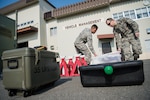 U.S. Air Force Senior Airman Michael Yingling, left, a 35th Logistics Readiness Squadron customer service technician, places a bucket of tools on the ground with Tech. Sgt. Garrett Dicus, right, the 35th LRS multipurpose maintenance section chief, during the first LRS agile combat employment exercise at Misawa Air Base, Japan, March 20, 2019. The ACE concept tests Airmen’s ability to demonstrate advanced readiness and forward thinking while responding to an unexpected contingency operation. (U.S. Air Force photo by Airman 1st Class Collette Brooks)
