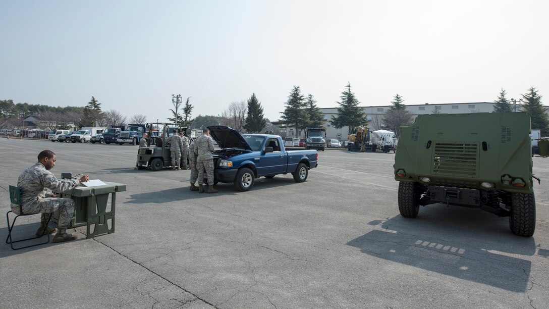 Airmen with the 35th Logistic Readiness Squadron work on inoperable vehicles during the first LRS Agile Combat Employment exercise at Misawa Air Base, Japan, March 20, 2019. The primary objective of the exercise was to fix a small pickup truck and a standard fork lift with an array of mechanical issues while having a limited number of tools to work with, similar to the work environment 35th LRS Airmen would face in a real-world evacuation or expeditionary setting (U.S. Air Force photo by Airman 1st Class Collette Brooks)