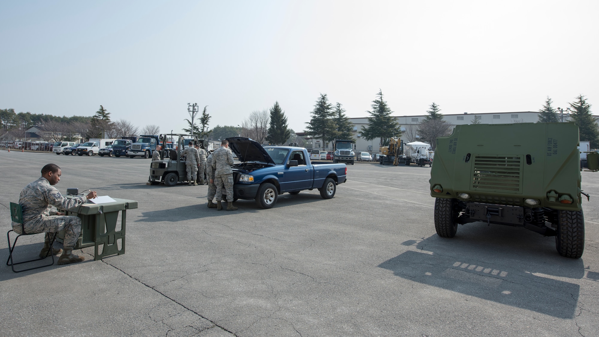 Airmen with the 35th Logistic Readiness Squadron work on inoperable vehicles during the first LRS Agile Combat Employment exercise at Misawa Air Base, Japan, March 20, 2019. The primary objective of the exercise was to fix a small pickup truck and a standard fork lift with an array of mechanical issues while having a limited number of tools to work with, similar to the work environment 35th LRS Airmen would face in a real-world evacuation or expeditionary setting (U.S. Air Force photo by Airman 1st Class Collette Brooks)